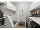 Well-organized laundry room with a dog washing station, white cabinets, subway tile, and modern washer and dryer at 9873 Lost Creek Dr, Winter Garden, FL 34787