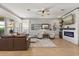 Spacious living room with stone fireplace, ceiling fan, and large windows at 9873 Lost Creek Dr, Winter Garden, FL 34787