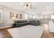 Open living room with gray sofa, ceiling fan, rug, and hardwood floors at 9873 Lost Creek Dr, Winter Garden, FL 34787