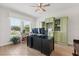 Bright office with a large window, custom built-ins, and a ceiling fan for a comfortable workspace at 9873 Lost Creek Dr, Winter Garden, FL 34787