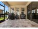 Covered patio with stone flooring and views of the beautiful, landscaped backyard with modern grill equipment at 9873 Lost Creek Dr, Winter Garden, FL 34787