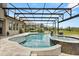 Beautiful backyard screened-in pool and spa with lush green views of the yard beyond the screen at 9873 Lost Creek Dr, Winter Garden, FL 34787