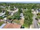 An aerial view of a cozy home, with mature trees and a large yard, in a quiet, residential neighborhood at 1003 S Center St, Eustis, FL 32726
