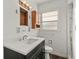 Bathroom featuring a black vanity, white countertop and walls, and open medicine cabinet at 1003 S Center St, Eustis, FL 32726