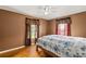 Cozy bedroom with hardwood floors and natural light from two windows at 1003 S Center St, Eustis, FL 32726