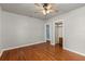 A bedroom with hardwood floors, a ceiling fan, and a closet at 1003 S Center St, Eustis, FL 32726