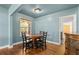 Cozy dining area featuring a round wood table, classic chairs, and natural light at 1003 S Center St, Eustis, FL 32726