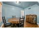 Intimate dining space with hardwood floors, classic wood furniture, and an open doorway at 1003 S Center St, Eustis, FL 32726