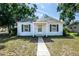 Charming one-story home with a walkway leading to the front door and classic curb appeal at 1003 S Center St, Eustis, FL 32726