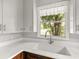 Bright kitchen featuring a white quartz countertop, modern faucet, undermount sink, and window with a view at 1003 S Center St, Eustis, FL 32726