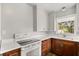 Well-lit kitchen featuring white countertops, dark wood cabinetry, and stainless steel oven at 1003 S Center St, Eustis, FL 32726
