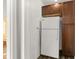 Functional kitchen space with a white refrigerator and wood storage cabinets at 1003 S Center St, Eustis, FL 32726