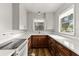 Modern kitchen with wood cabinets, white countertops, and stainless steel appliances at 1003 S Center St, Eustis, FL 32726