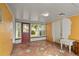 A sunroom with a door that leads to the outside, and multiple windows at 1003 S Center St, Eustis, FL 32726