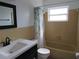 Bathroom featuring classic tile, updated vanity, and natural light from a window over the bathtub at 10208 Brownwood Ave, Orlando, FL 32825