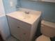 Bathroom featuring a vanity, and toilet, next to blue tiled wall at 10208 Brownwood Ave, Orlando, FL 32825