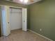 Bedroom featuring a closet with bi-fold doors, neutral walls, and tile flooring at 10208 Brownwood Ave, Orlando, FL 32825