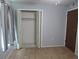 Bedroom featuring wood-look flooring and a closet with ample storage space and bi-fold doors at 10208 Brownwood Ave, Orlando, FL 32825