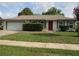 Charming single-story home with a well-maintained front yard and a two-car garage at 10208 Brownwood Ave, Orlando, FL 32825