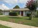 Charming single-story home with a well-maintained front yard and a two-car garage at 10208 Brownwood Ave, Orlando, FL 32825