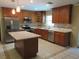 Well-lit kitchen features stainless steel appliances, granite countertops, and a breakfast bar at 10208 Brownwood Ave, Orlando, FL 32825