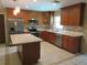 Well-lit kitchen features stainless steel appliances, granite countertops, and an island at 10208 Brownwood Ave, Orlando, FL 32825