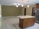 Spacious kitchen with breakfast bar and stainless steel refrigerator with ice and water dispenser at 10208 Brownwood Ave, Orlando, FL 32825