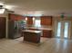 Open kitchen features stainless steel appliances, breakfast bar and ample cabinet storage space at 10208 Brownwood Ave, Orlando, FL 32825