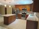 Updated kitchen with stainless steel appliances, granite countertops, and breakfast bar at 10208 Brownwood Ave, Orlando, FL 32825