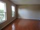 Bright living room with hardwood floors and large windows offering ample natural light at 10208 Brownwood Ave, Orlando, FL 32825