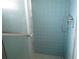 Shower stall featuring glass doors, tiled walls, and showerhead with controls at 10208 Brownwood Ave, Orlando, FL 32825