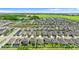 Aerial shot displays a large community with modern homes and landscaped yards, highlighted by a nearby pond and open green areas at 1120 Mattie Pointe Blvd, Auburndale, FL 33823