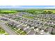 A wide aerial shot capturing a residential neighborhood with consistent architectural styles, featuring serene ponds and green spaces in the distance at 1120 Mattie Pointe Blvd, Auburndale, FL 33823