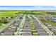 An aerial perspective shows a neighborhood with manicured lawns and gray roofs, set against a backdrop of lush greenery and blue skies at 1120 Mattie Pointe Blvd, Auburndale, FL 33823
