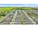 Aerial view of a community with neat homes and well-maintained green spaces, under a clear sky with distant water views at 1120 Mattie Pointe Blvd, Auburndale, FL 33823