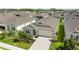 Bird's eye view of a single-Gathering home with a two-car garage and manicured lawn in a residential neighborhood at 1120 Mattie Pointe Blvd, Auburndale, FL 33823