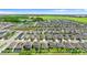 A panoramic aerial view captures a community of neatly arranged houses with manicured lawns and a tranquil pond in the distance at 1120 Mattie Pointe Blvd, Auburndale, FL 33823