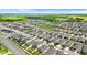 Wide aerial view of a well-ordered community showcases uniform house styles, complete with ponds, and landscaped surroundings at 1120 Mattie Pointe Blvd, Auburndale, FL 33823