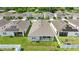 Aerial view showcasing a home with a well-manicured lawn, covered patio, and solar panels at 1120 Mattie Pointe Blvd, Auburndale, FL 33823