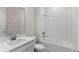 Clean bathroom features white subway tiles, a bathtub with a shower, and a modern vanity with a sink at 1120 Mattie Pointe Blvd, Auburndale, FL 33823