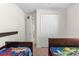 Bedroom view highlighting two beds, closet, and adjacent room; features neutral paint and carpeted flooring at 1120 Mattie Pointe Blvd, Auburndale, FL 33823