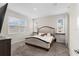Bedroom featuring a large bed, two windows, and a dresser, showcasing comfortable living at 1120 Mattie Pointe Blvd, Auburndale, FL 33823