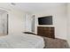 Bedroom with a flat screen tv, dresser, and doorway to the bathroom, providing a private suite at 1120 Mattie Pointe Blvd, Auburndale, FL 33823