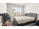 Well-lit bedroom with a upholstered bed, large windows, and a bedside table, offering relaxation at 1120 Mattie Pointe Blvd, Auburndale, FL 33823