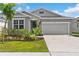 Charming single-story home features a well-maintained lawn, landscaping, and a two-car garage at 1120 Mattie Pointe Blvd, Auburndale, FL 33823