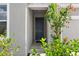 Close-up of the home's front entry featuring a dark-colored door and decorative stone accents at 1120 Mattie Pointe Blvd, Auburndale, FL 33823