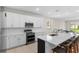 Beautiful kitchen with white cabinets, stainless steel appliances, a large island, and seamless access to the dining area at 1120 Mattie Pointe Blvd, Auburndale, FL 33823