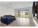 Bright living room features tile flooring and sliding glass doors to the backyard at 1120 Mattie Pointe Blvd, Auburndale, FL 33823