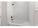 Clean bathroom featuring a white tiled shower with sleek fixtures and bright lighting at 1120 Mattie Pointe Blvd, Auburndale, FL 33823