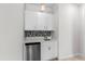 Charming wet bar features white cabinetry, stainless steel appliances, and unique backsplash, creating a stylish area at 1120 Mattie Pointe Blvd, Auburndale, FL 33823